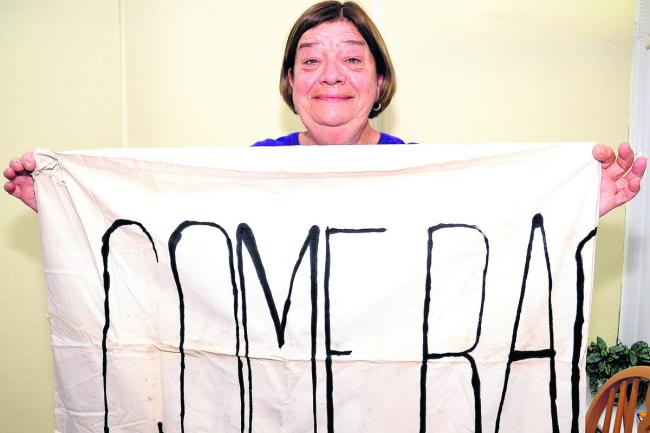 Joan Britton today with the banner she made appealing for the Beatles to  come back from the USA