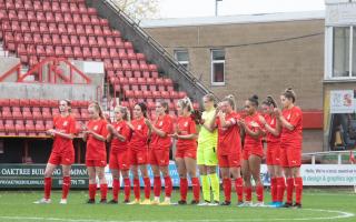 The Swindon Town Women's team pays their respects to Carla Heaton before the game.